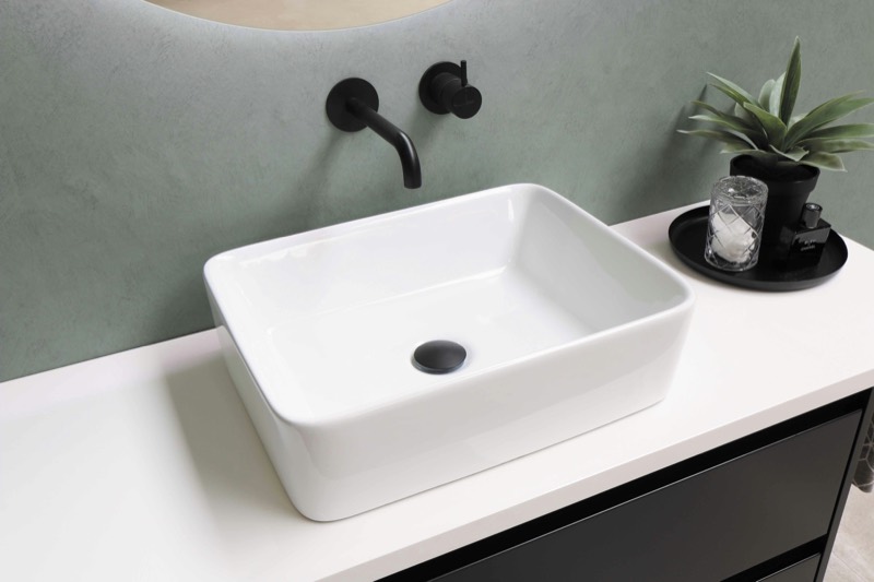 A clear bathroom counter with a clean basin